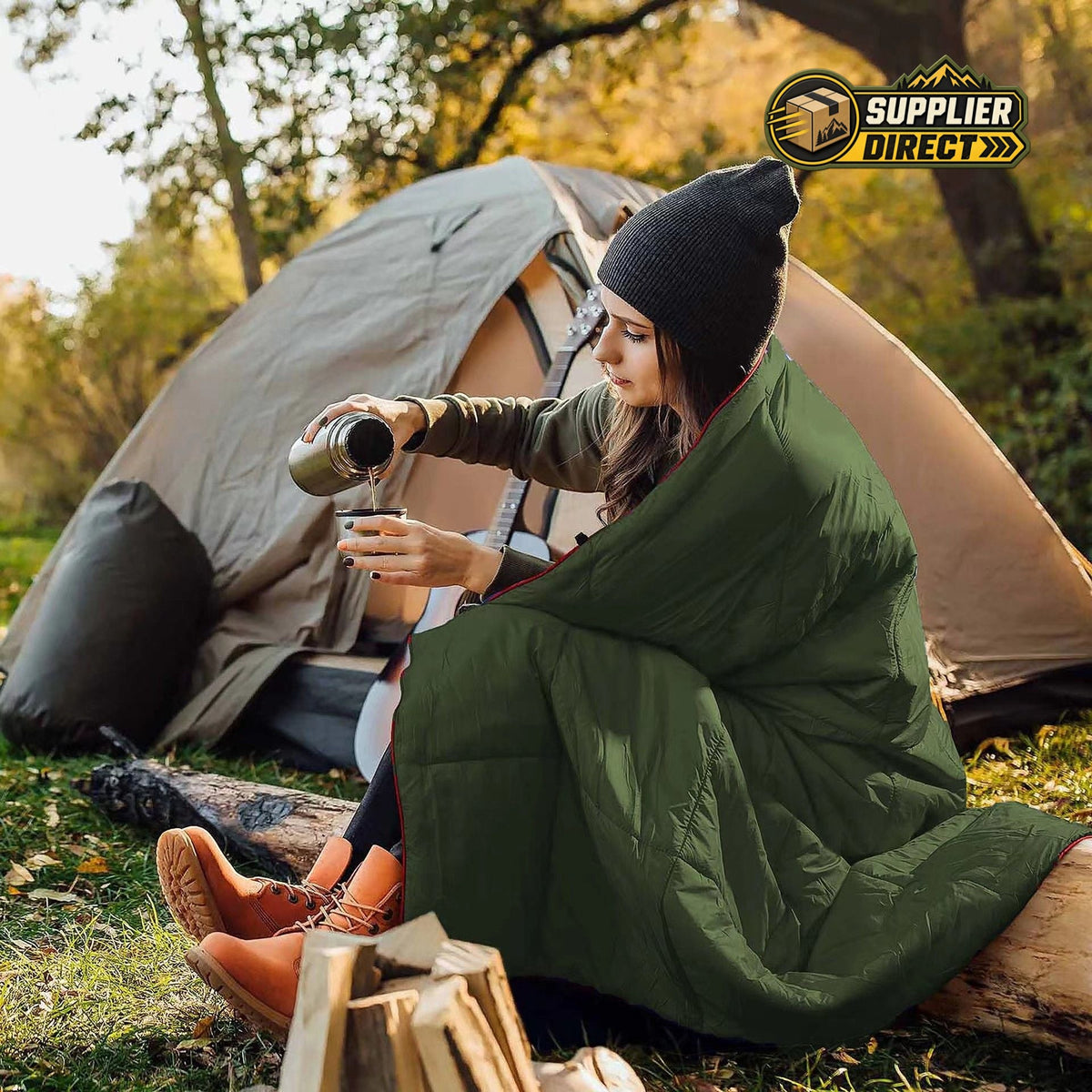 PrepPro Australia green quilted wearable camping blanket draped over a woman sitting by a tent outdoors