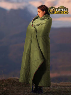 PrepPro Australia wearable green quilted camping blanket draped over a woman outdoors at sunset