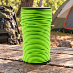 100m Outdoor Paracord Survival Rope - Green on a campsite table